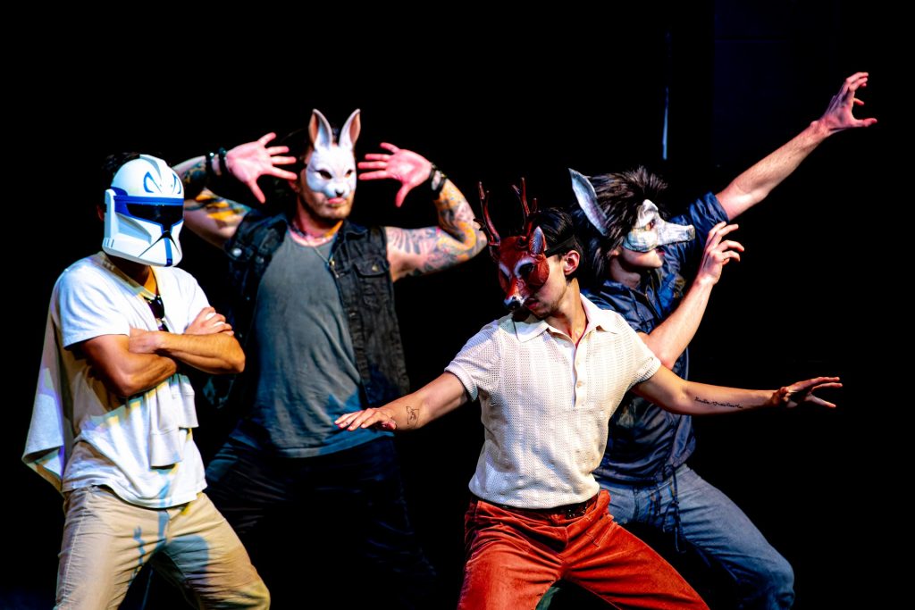 Four men, masked and posing, in Love's Labour's Lost for Prague Shakespeare Company 2023